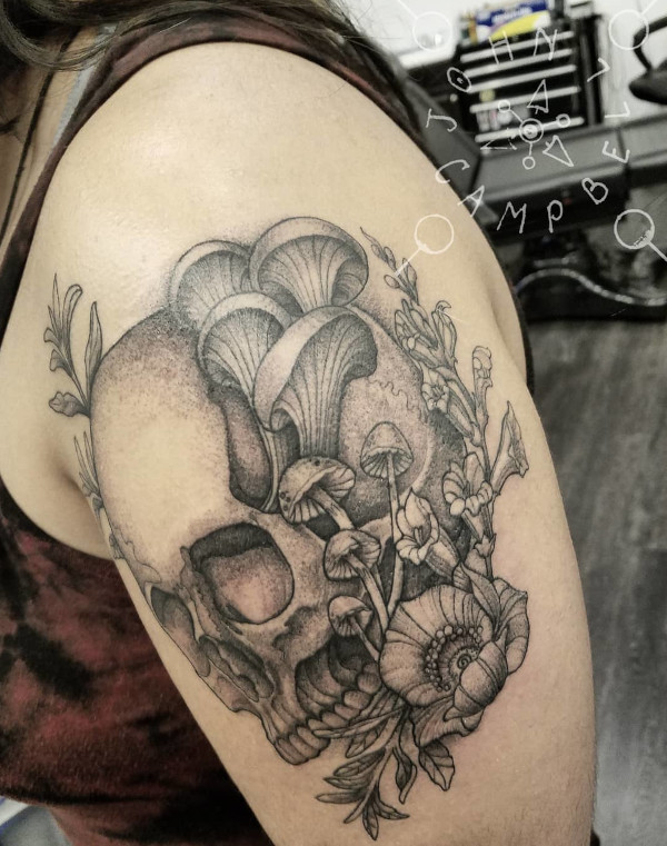 Skull with mushrooms and wildflowers black and grey tattoo by John Campbell at Sacred Mandala Studio tattoo parlor in Durham, NC.